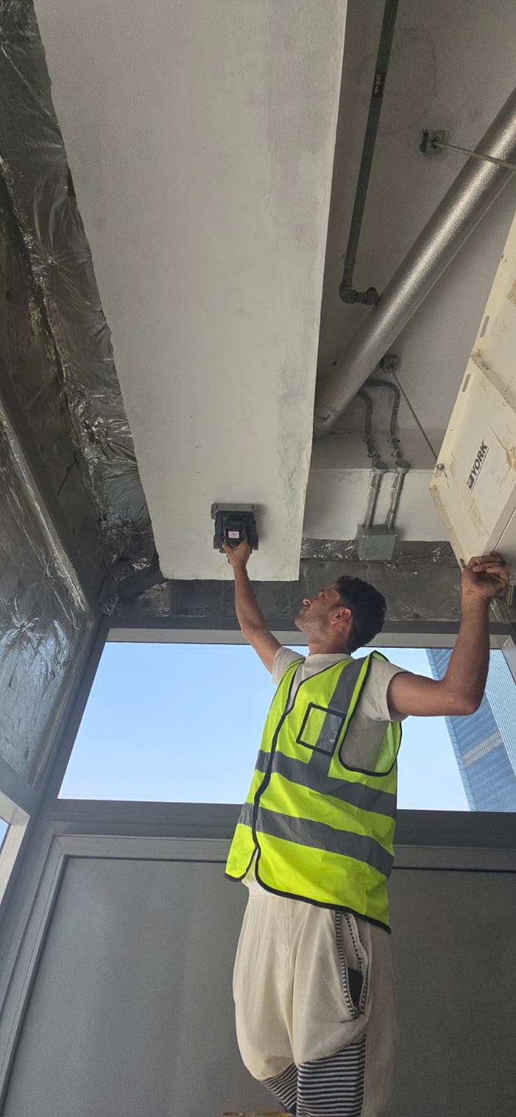 Bhadeya Technical Services GPR scanning at construction site Dubai - technician using ground penetrating radar on ceiling